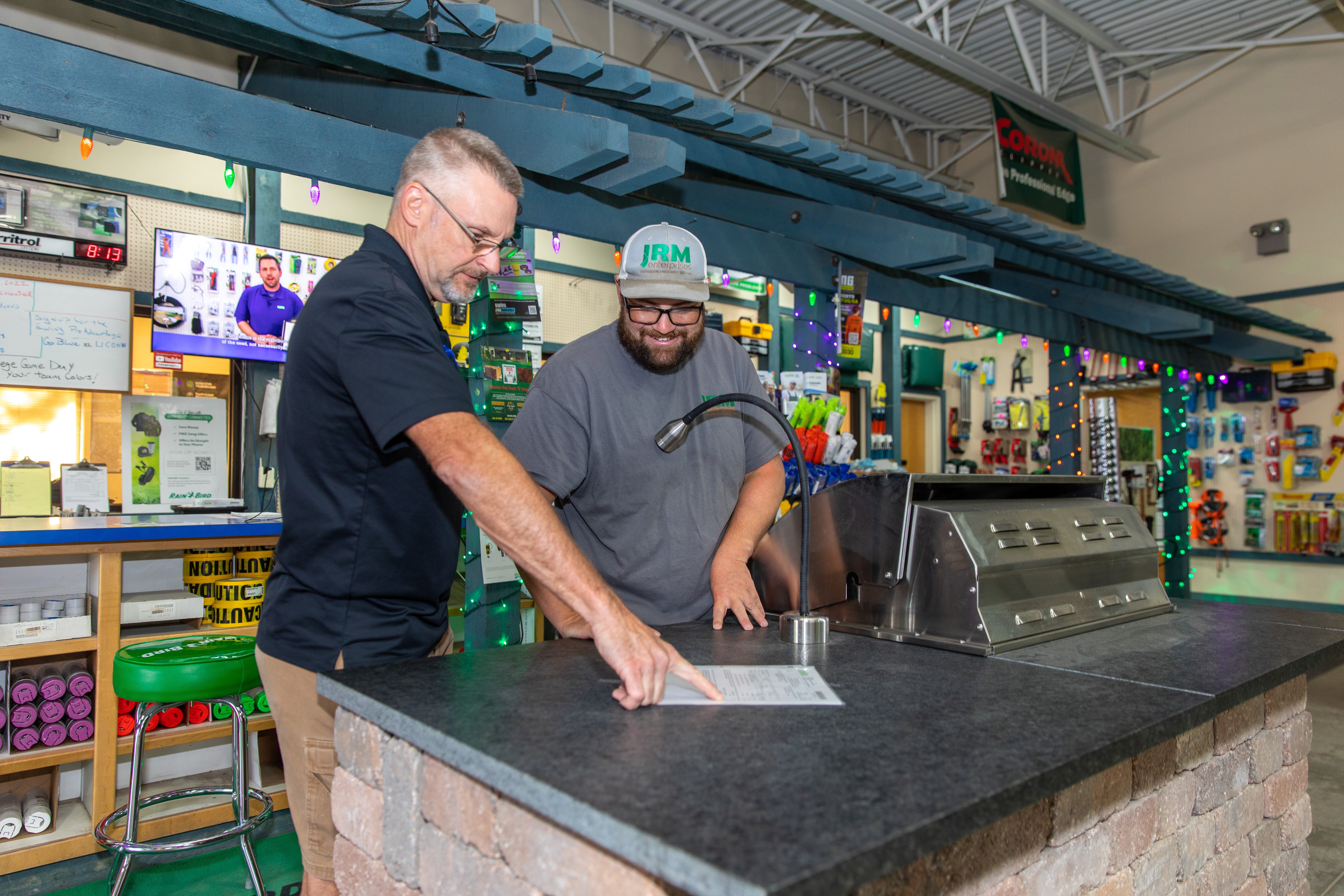 Ewing employee going over information with a customer inside a Ewing branch (Photo courtesy of Kyle Ellsworth/Ewing Outdoor Supply)