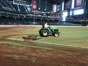 Grooming infill into the new synthetic turf field. Infill provides improved playability. 