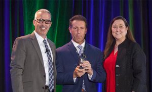Warren Gorowitz, Ewing VP of Sustainability, Marc Logan, Chief Agronomist and Principal at Greenway Golf and Christine Kane, CEO of Audubon International at the Water & Sustainability Innovation Award presentation in Phoenix, Arizona. (Photo Credit: Ewing Irrigation & Landscape Supply)