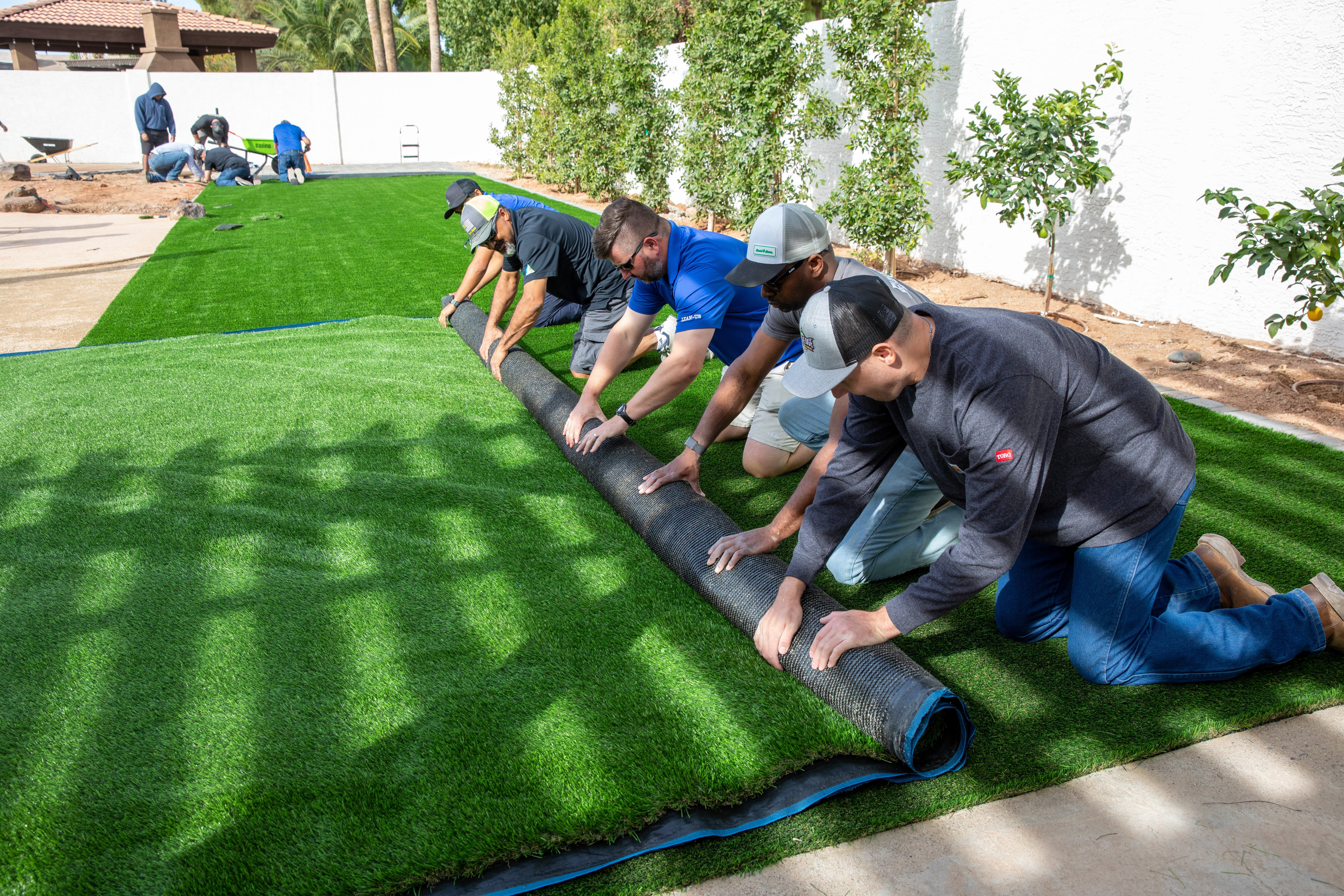 Ewing employees rolling up turf during a synthetic turf install class. (Photo taken by Kyle Ellsworth/Ewing Outdoor Supply)