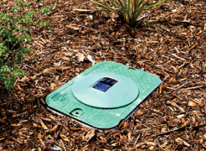 A DIG LEIT irrigation controller mounted below ground level.
